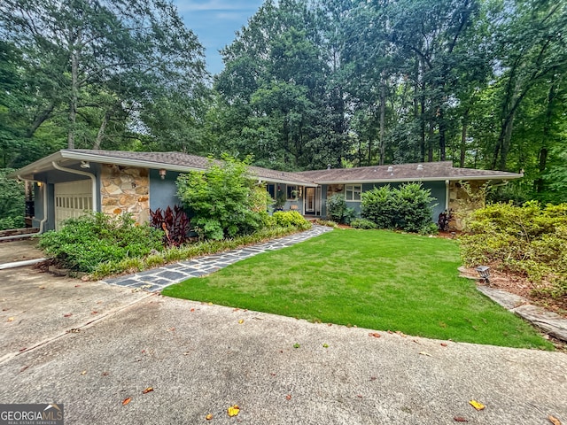 ranch-style home featuring a garage and a front yard