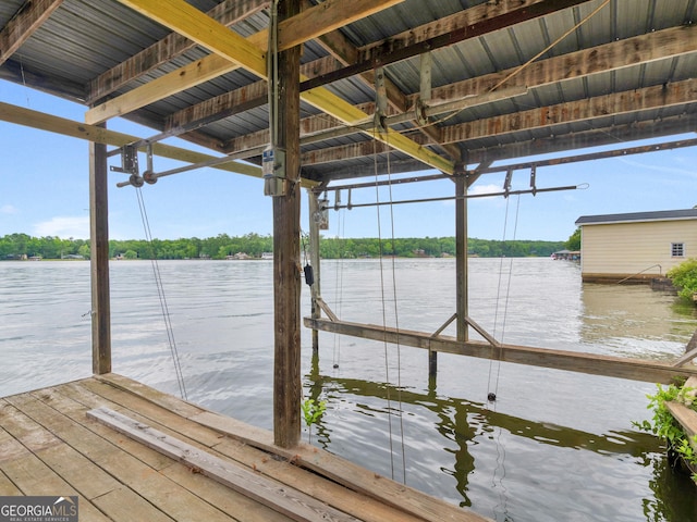 view of dock with boat lift and a water view