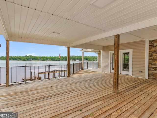 wooden terrace featuring a water view, boat lift, and a boat dock