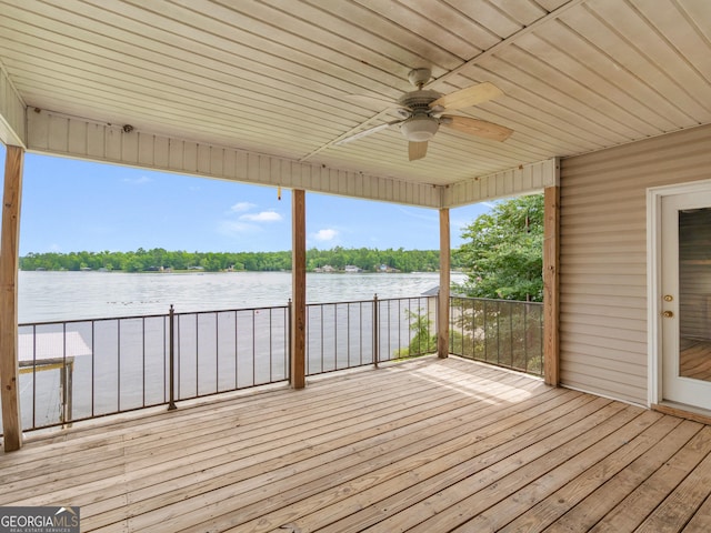 deck with a water view and ceiling fan