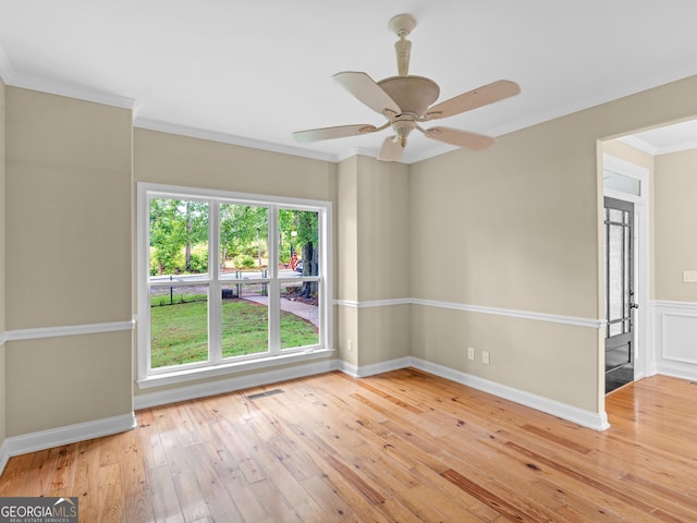 unfurnished room with visible vents, ornamental molding, baseboards, a ceiling fan, and light wood finished floors