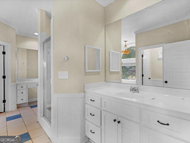 bathroom featuring an enclosed shower, vanity, ornamental molding, and tile patterned floors