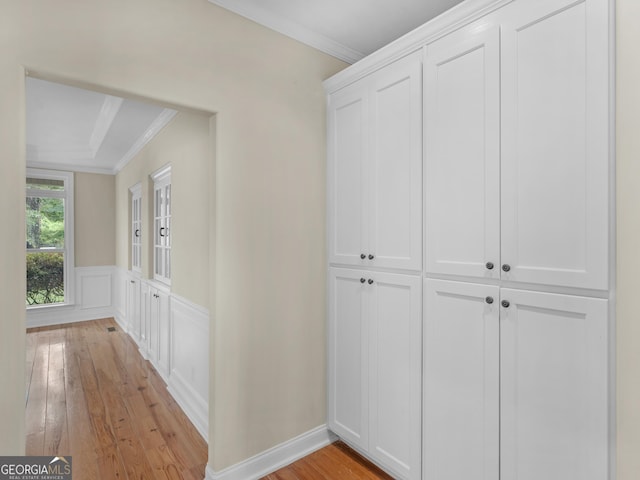 corridor featuring light hardwood / wood-style flooring and ornamental molding