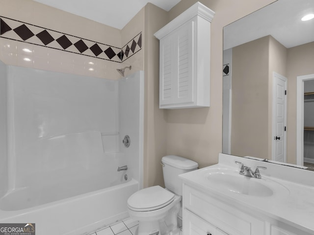 bathroom featuring toilet,  shower combination, a walk in closet, and vanity