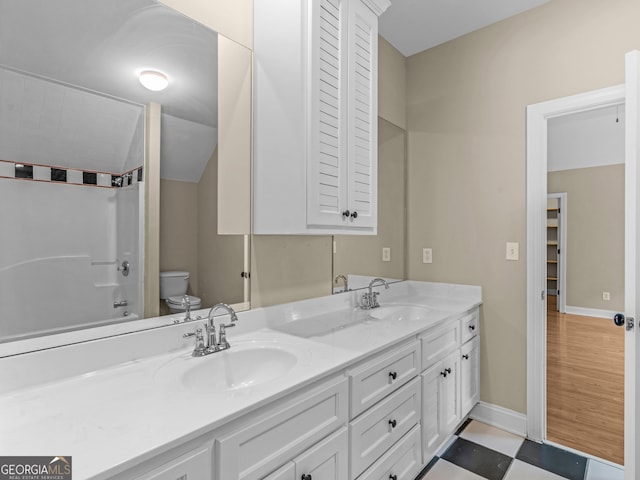 10766 Ga Highway 212, Monticello, GA 31064 - bathroom featuring toilet, double vanity, bathtub / shower combination, and baseboards