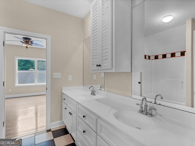 bathroom featuring hardwood / wood-style flooring, ceiling fan, and vanity