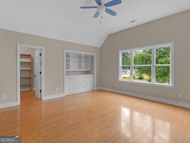 unfurnished bedroom featuring a walk in closet, light wood-type flooring, and visible vents