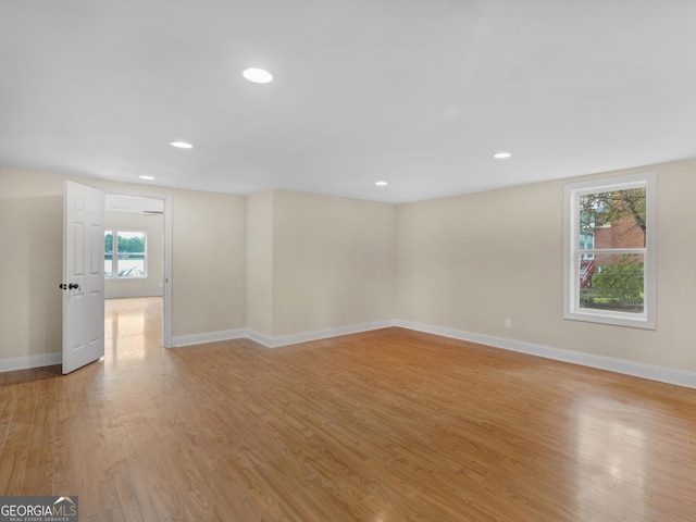interior space featuring recessed lighting, baseboards, and light wood finished floors