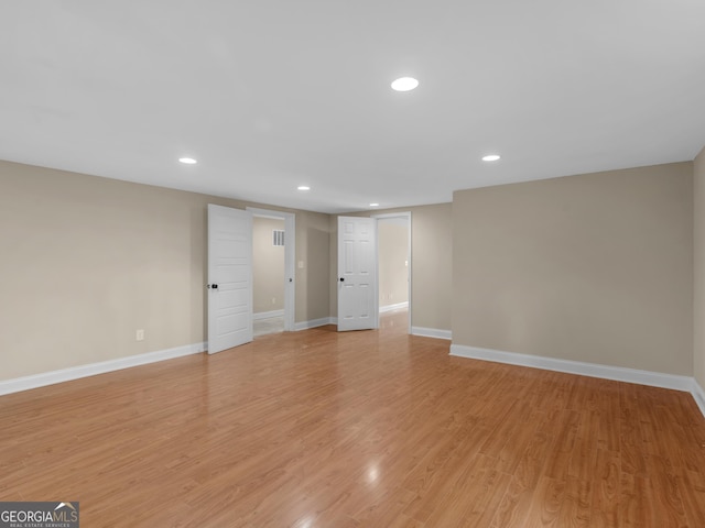 unfurnished living room featuring baseboards, recessed lighting, and light wood-style flooring