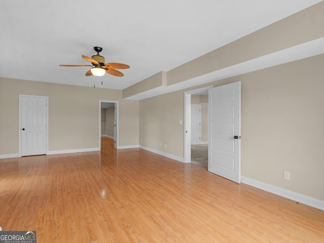 unfurnished room with ceiling fan, baseboards, and light wood-style floors