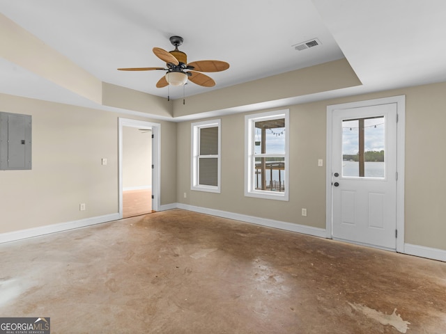 entryway with baseboards, a ceiling fan, electric panel, and unfinished concrete flooring