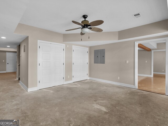 unfurnished bedroom featuring multiple closets, electric panel, and ceiling fan