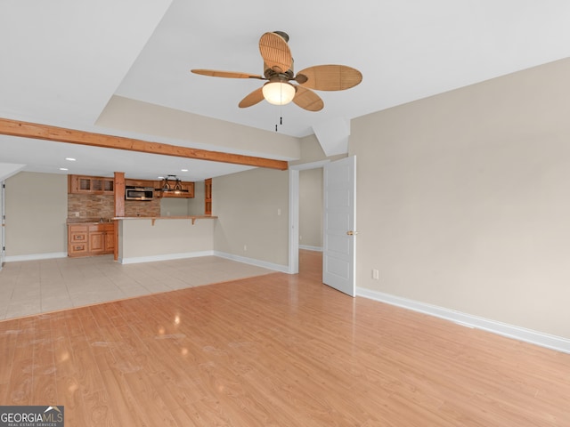 unfurnished living room featuring light wood-type flooring, a ceiling fan, baseboards, and recessed lighting