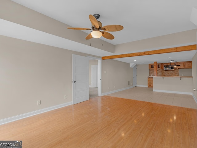 unfurnished living room with recessed lighting, baseboards, a ceiling fan, and light wood-type flooring