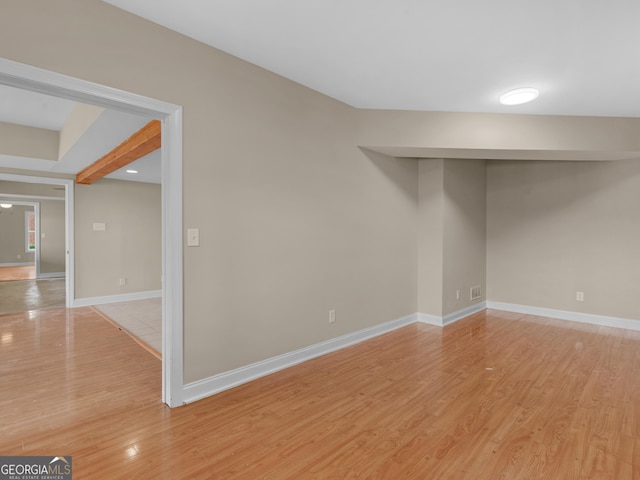 spare room featuring recessed lighting, baseboards, and light wood-style floors