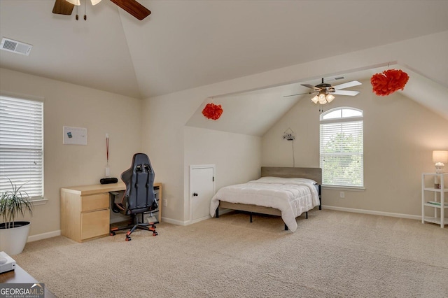 carpeted bedroom with ceiling fan and vaulted ceiling