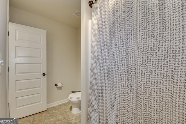 bathroom with tile patterned floors and toilet