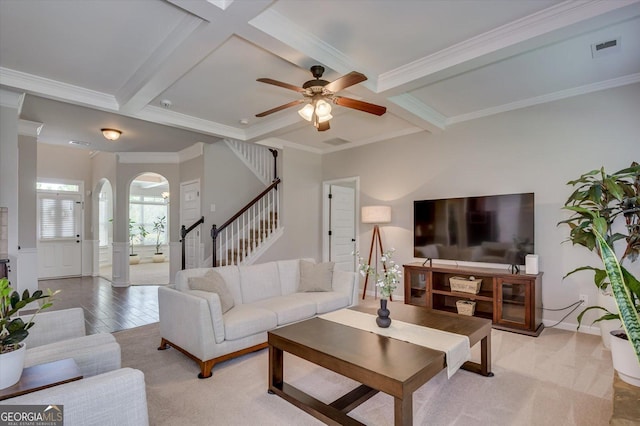 living room with beamed ceiling, ceiling fan, ornamental molding, and coffered ceiling