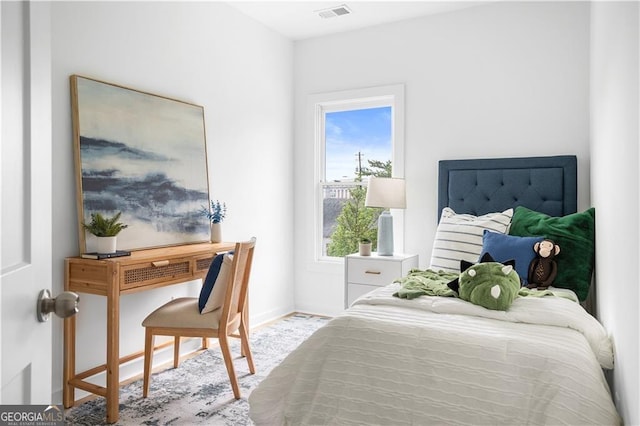 bedroom featuring baseboards and visible vents