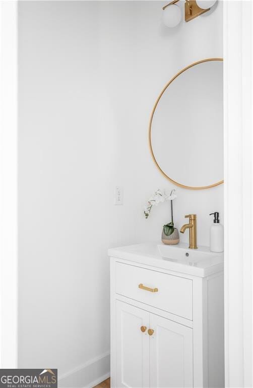 bathroom featuring baseboards and vanity