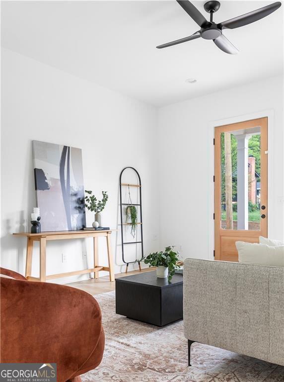 living area featuring a ceiling fan