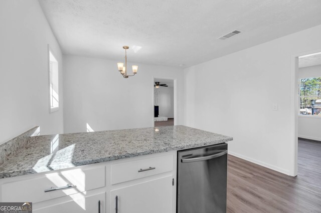 kitchen with white cabinetry, light stone counters, pendant lighting, stainless steel dishwasher, and hardwood / wood-style flooring