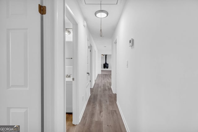 corridor with hardwood / wood-style flooring