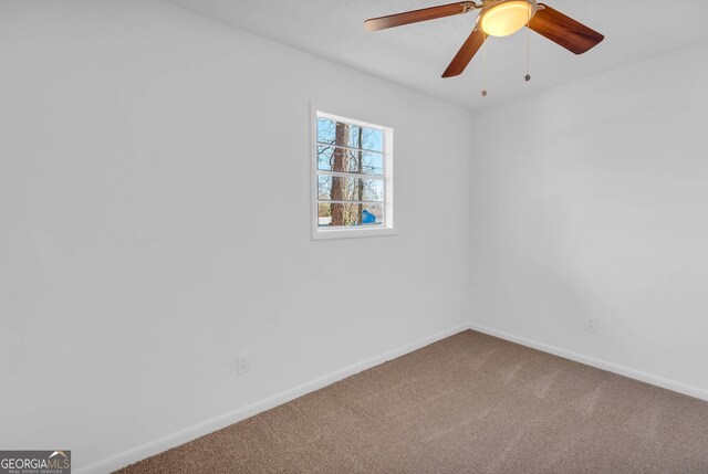 spare room featuring carpet and ceiling fan