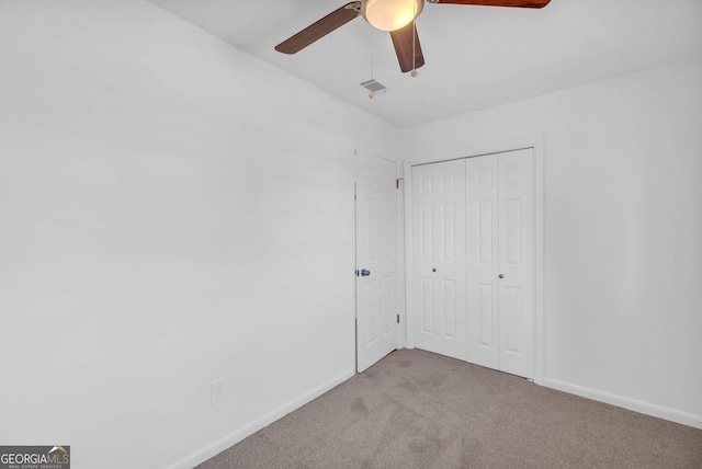 unfurnished bedroom featuring a closet, ceiling fan, and carpet floors