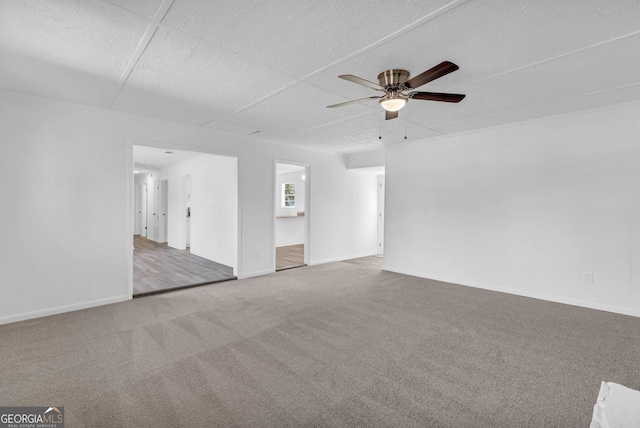 spare room featuring carpet flooring and ceiling fan