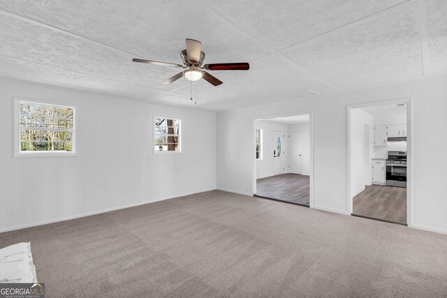 unfurnished room featuring light carpet and ceiling fan