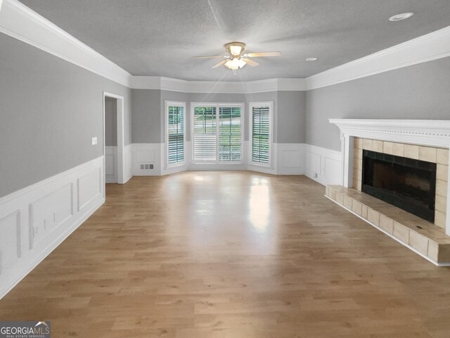 spare room featuring carpet flooring, a textured ceiling, a raised ceiling, and ceiling fan