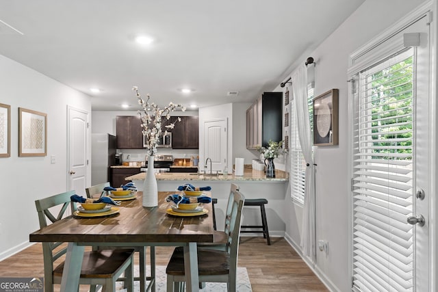 dining area featuring hardwood / wood-style floors and sink