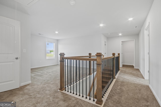 hallway featuring light carpet