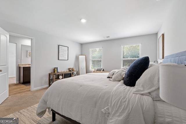 carpeted bedroom with ensuite bath