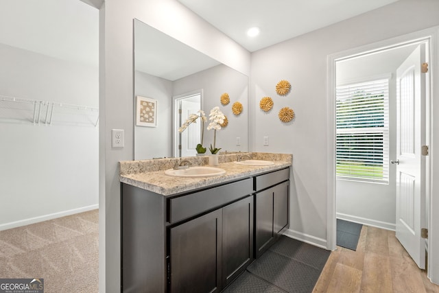 bathroom with hardwood / wood-style floors and vanity