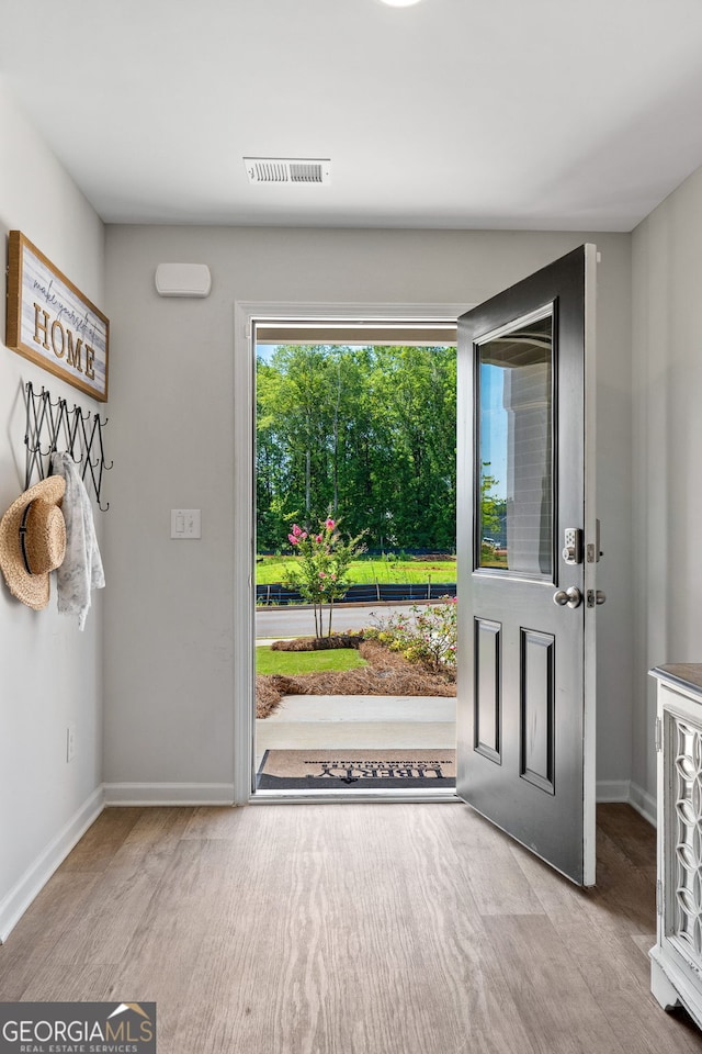 doorway to outside with light hardwood / wood-style floors