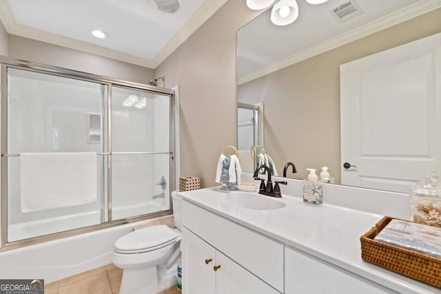 full bathroom featuring crown molding, combined bath / shower with glass door, tile patterned floors, and toilet