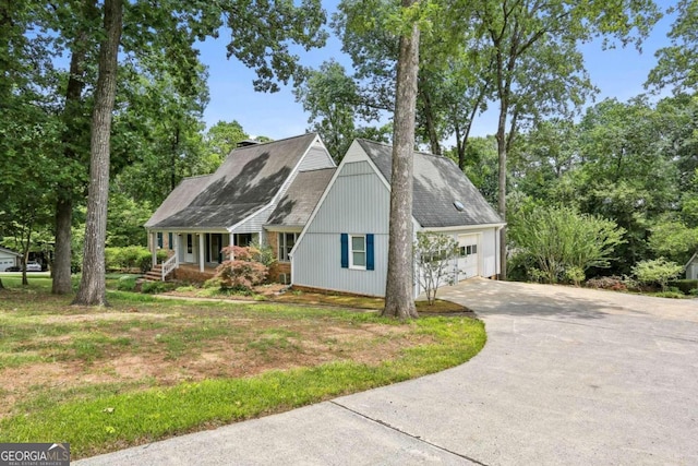 cape cod-style house with a front yard and a garage