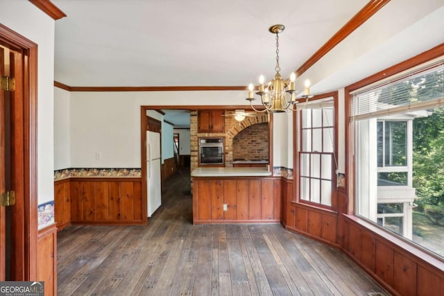 kitchen with dark wood-type flooring, an inviting chandelier, oven, white fridge, and a fireplace