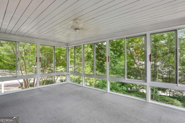 unfurnished sunroom with wood ceiling