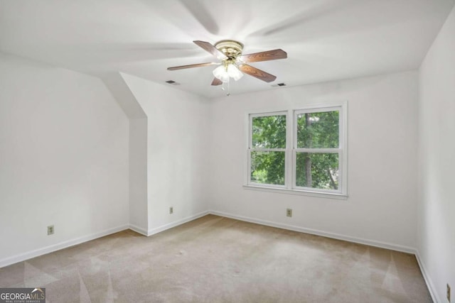 spare room with light carpet and ceiling fan