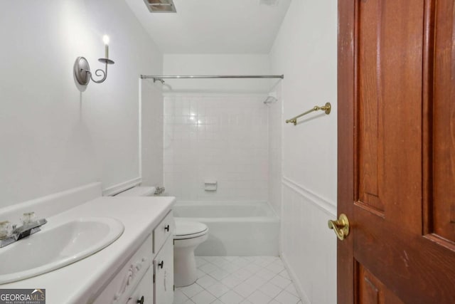 full bathroom with tile patterned floors, vanity, toilet, and tiled shower / bath combo