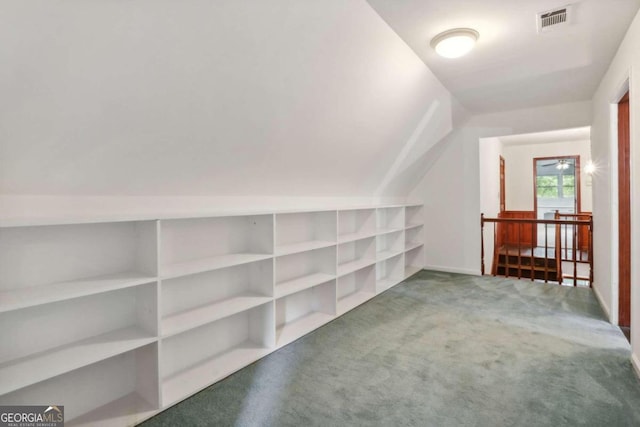 additional living space with carpet flooring and lofted ceiling