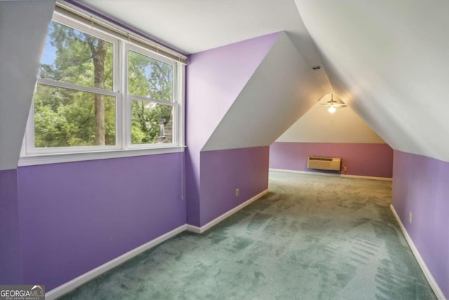 additional living space with an AC wall unit, ceiling fan, carpet floors, and vaulted ceiling