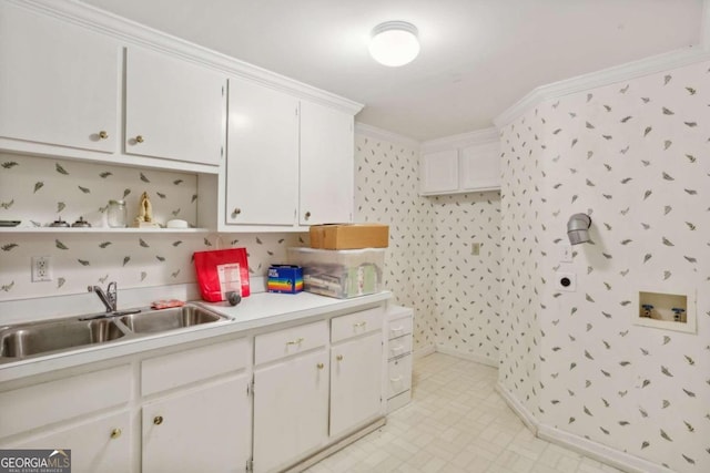 kitchen featuring white cabinetry, sink, and ornamental molding