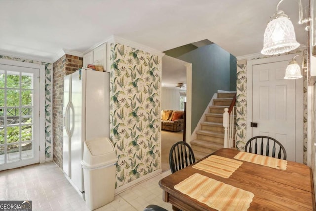 dining room with ceiling fan and crown molding