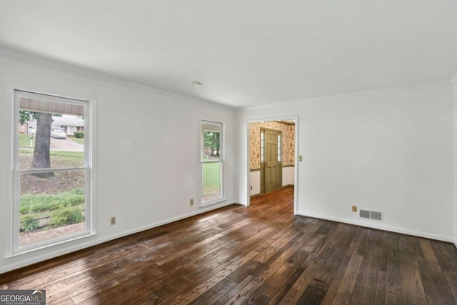 spare room with dark hardwood / wood-style flooring and crown molding