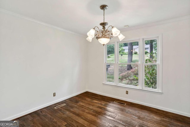 empty room featuring crown molding, a chandelier, and dark hardwood / wood-style floors