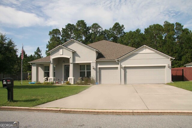 view of front of home featuring a front yard and a garage